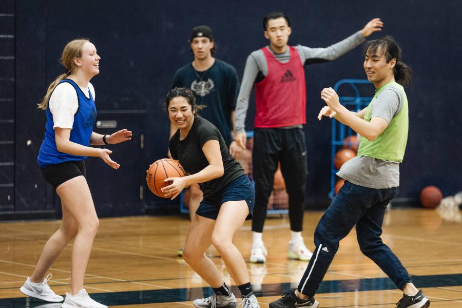 people playing basketball in the gym