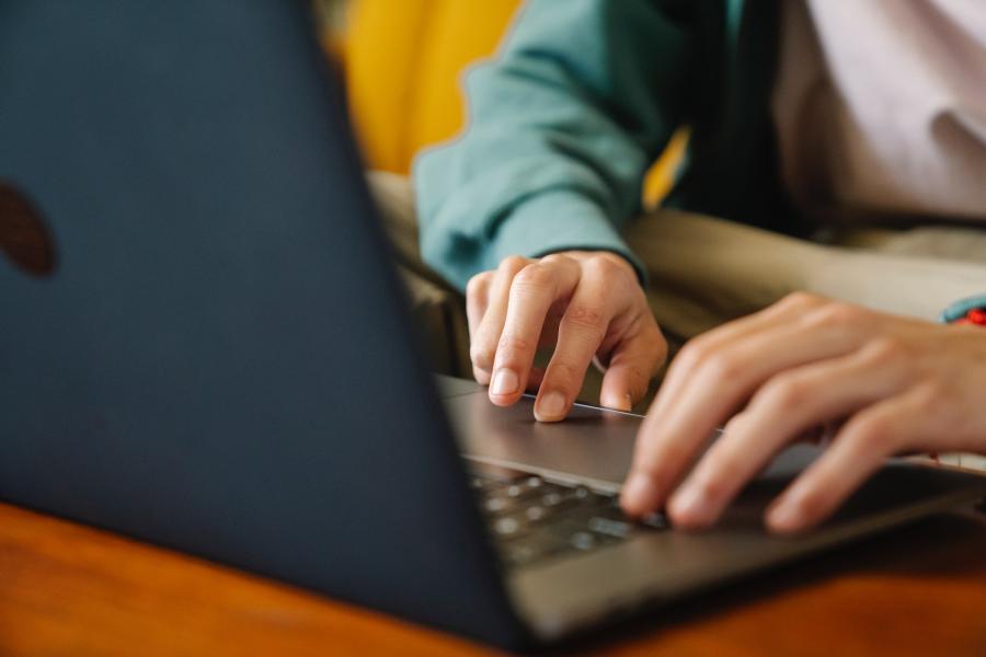 hands typing on computer