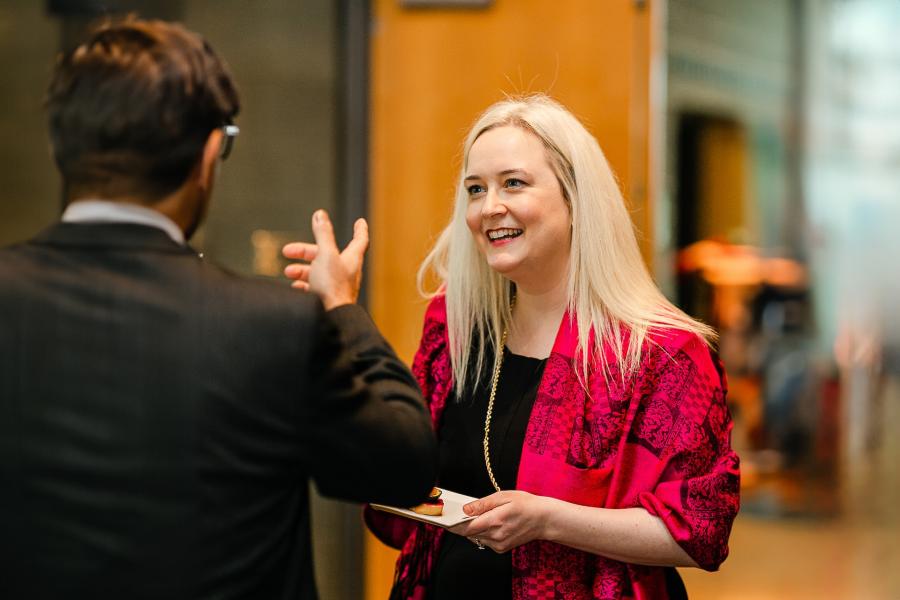 Rochelle Salazar talking with someone at a reception
