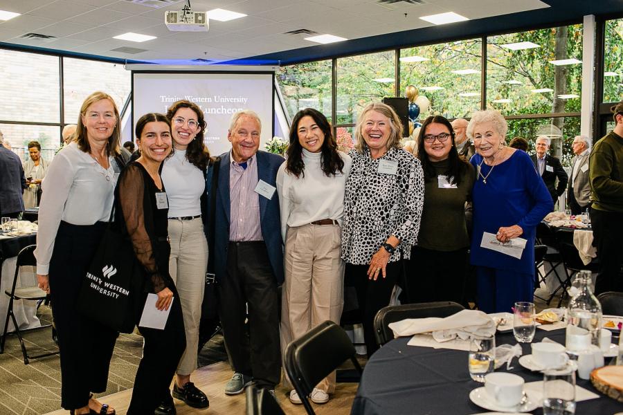 students and donors smiling as a group at a Legacy Luncheon 