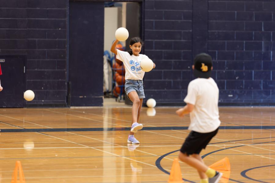 A girl throwing a dodgeball