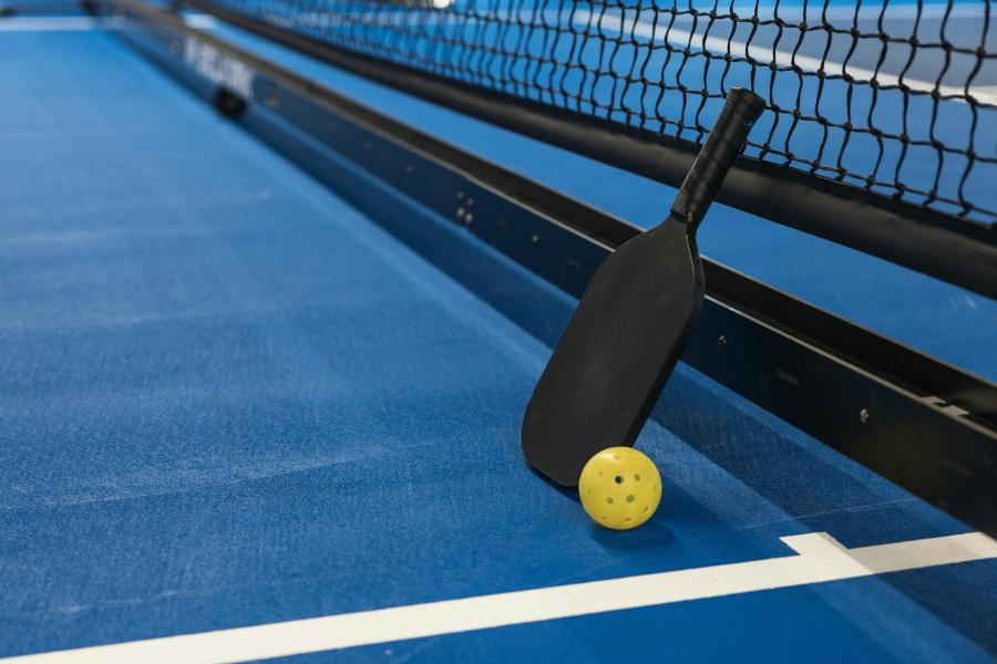 A pickleball paddle and net.