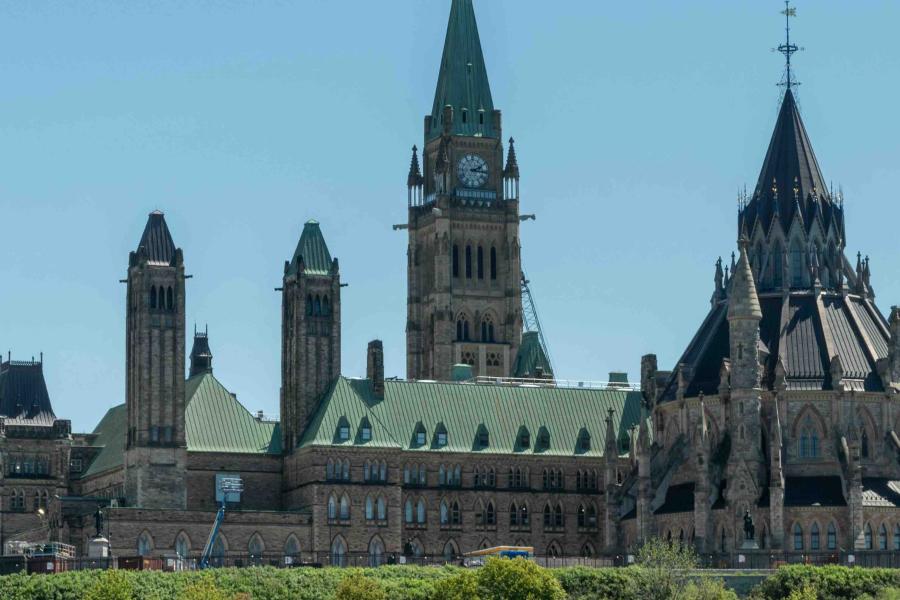 Ottawa Parliament Hill with the Peace Tower and Canadian flag.