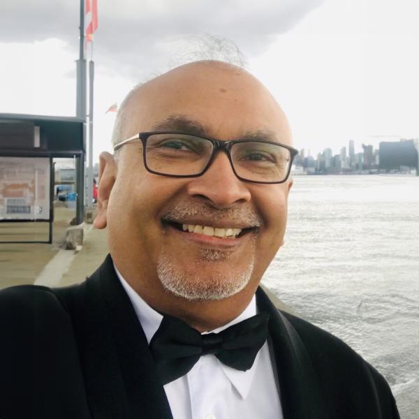 Derrick Mohamed standing in front of water