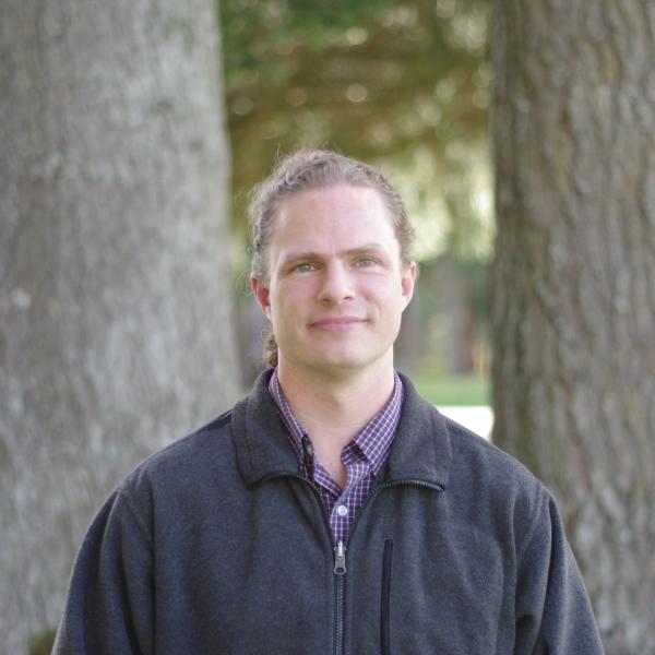 dennis venema standing in front of a tree