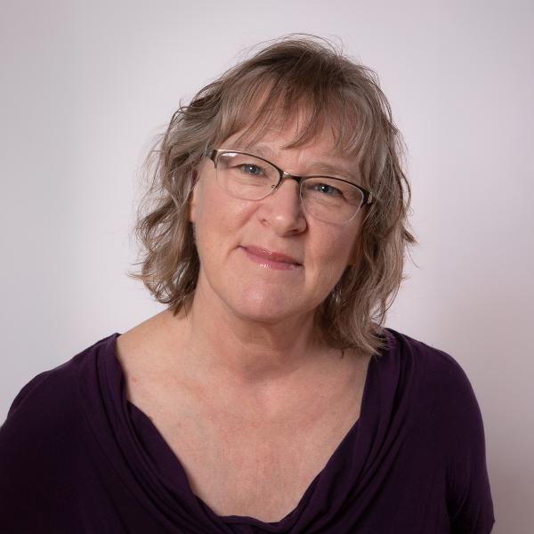 Darlaine Jantzen standing in front of a white wall