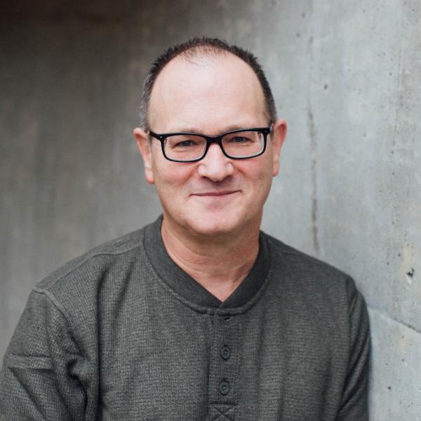 Craig Allert standing in front of grey wall