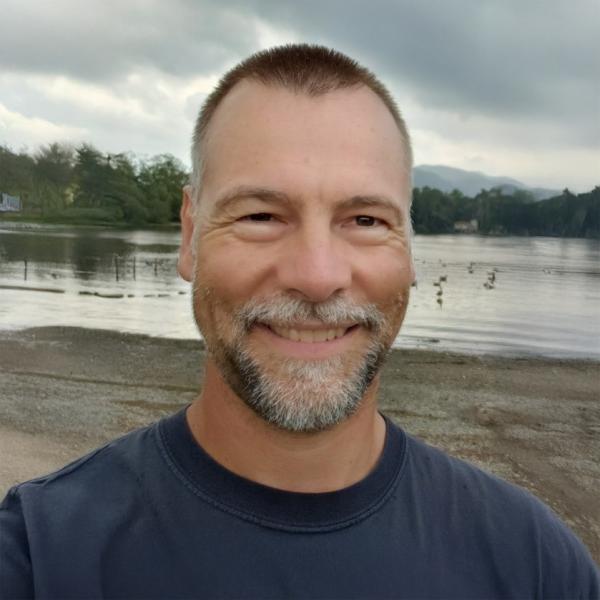 Christian Klaue standing in front of a lake