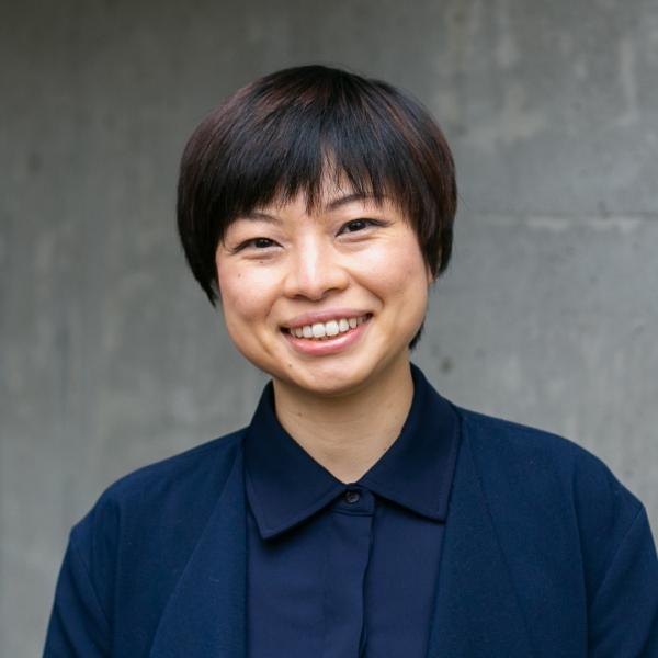 Winnie Lui standing in front of grey wall