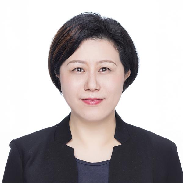 Professional portrait Lili Sha in a black blazer, smiling gently.