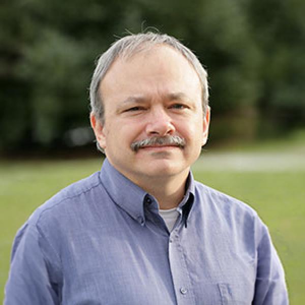 Roderic Casali headshot in front of green background