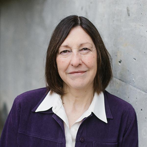 Landa Terblance standing in front of a grey wall