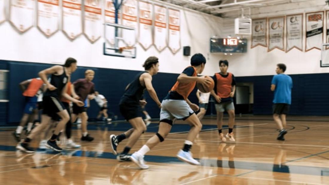 people playing basketball in the gym