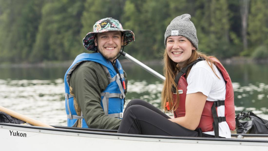 people smiling in canoe