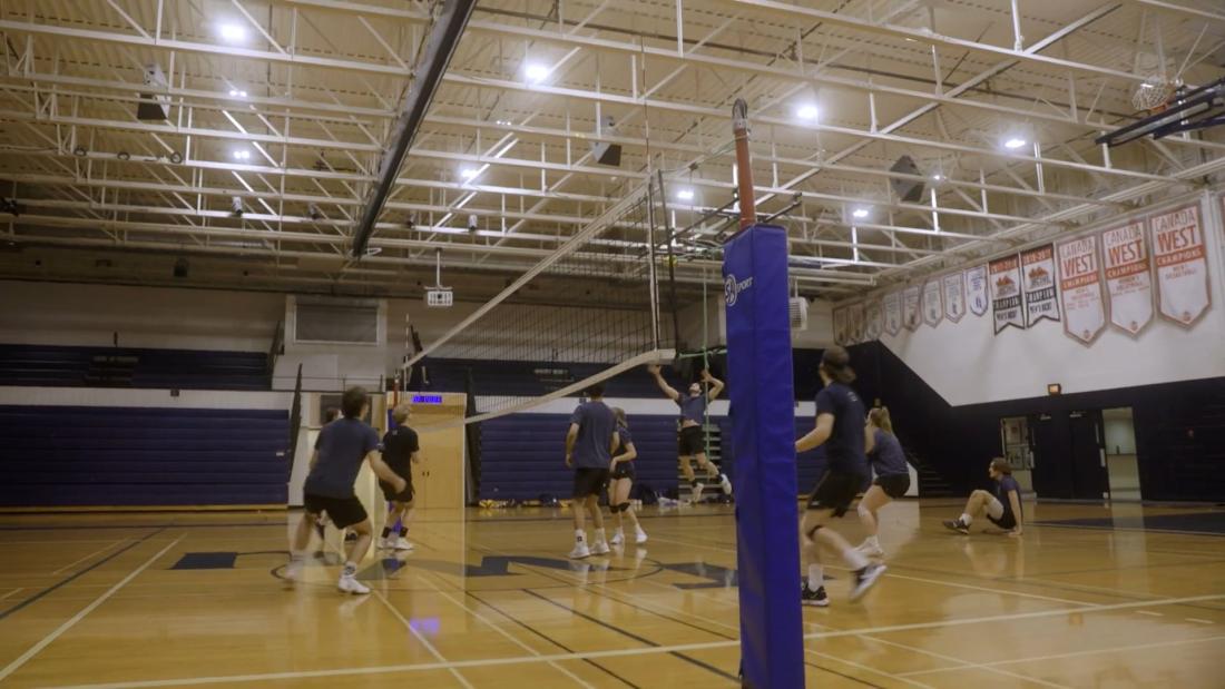 people playing volleyball in the gym