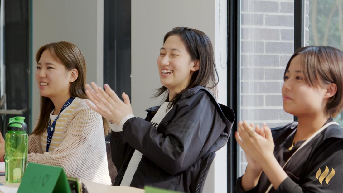 people smiling and clapping