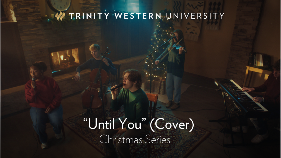 People singing in front of christmas decorations