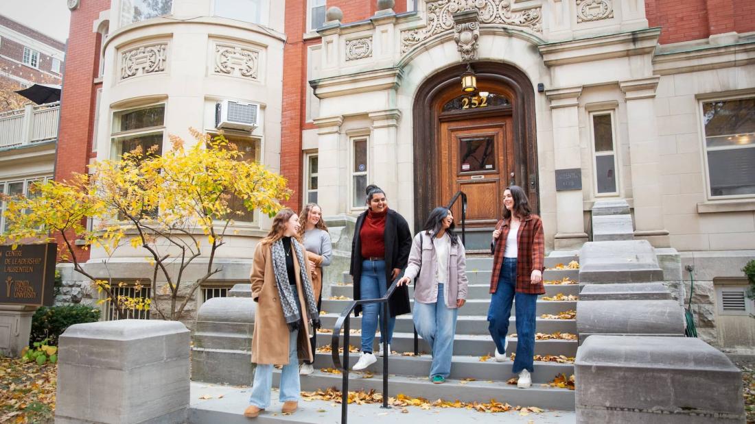 five women walking down the steps of the LLC