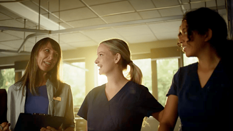 nursing student learning in lab with instructor