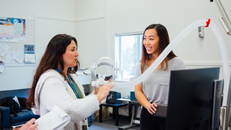 Student and instructor in lab with respitory equipment.