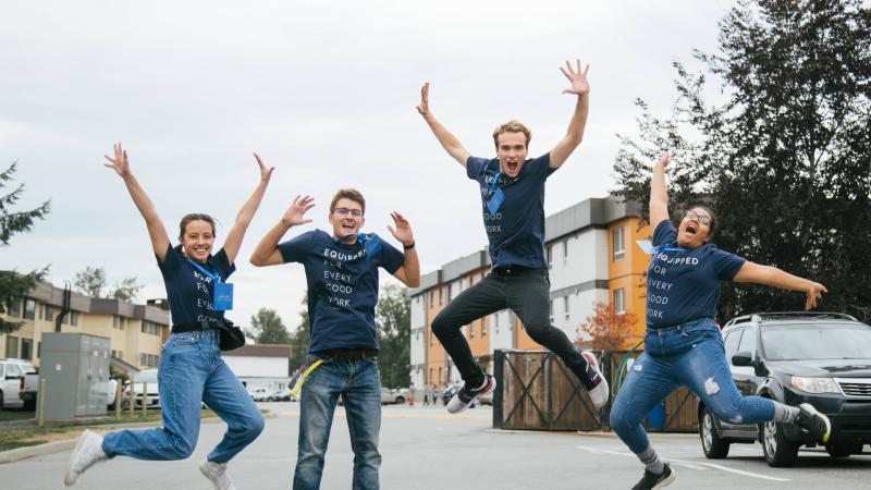 Students jumping with arms up, wearing TWU "Equipped for every good work" shirts.
