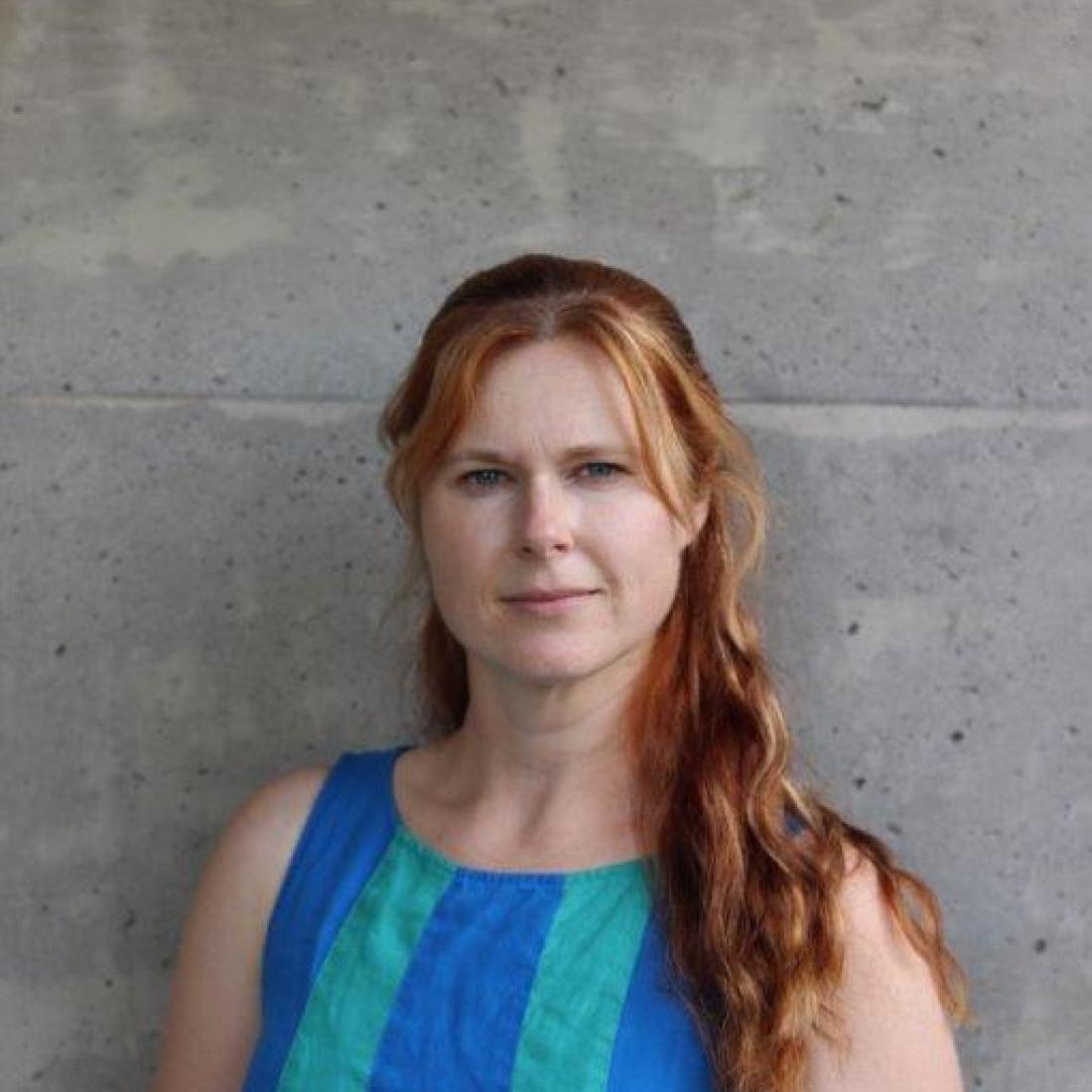 headshot of person in front of wall
