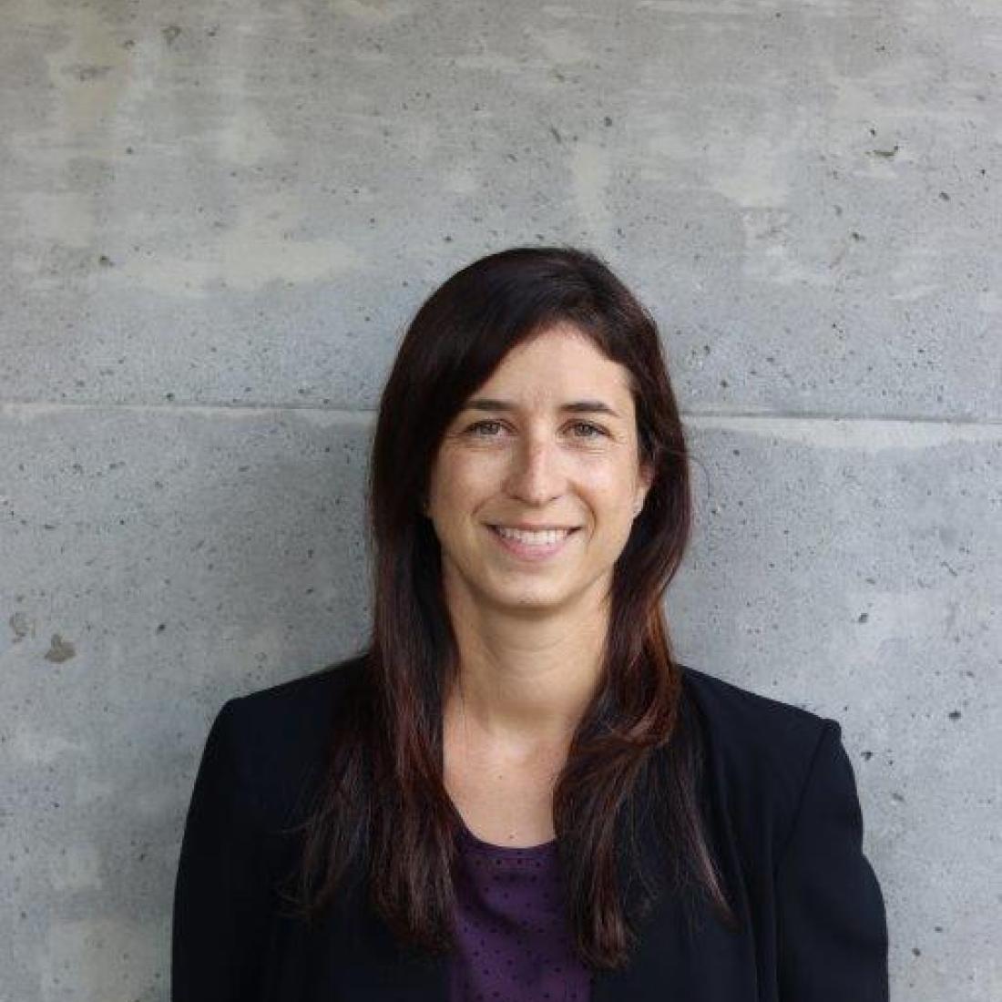 headshot of person in front of wall