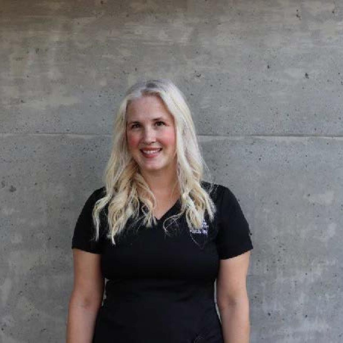 headshot of person in front of wall