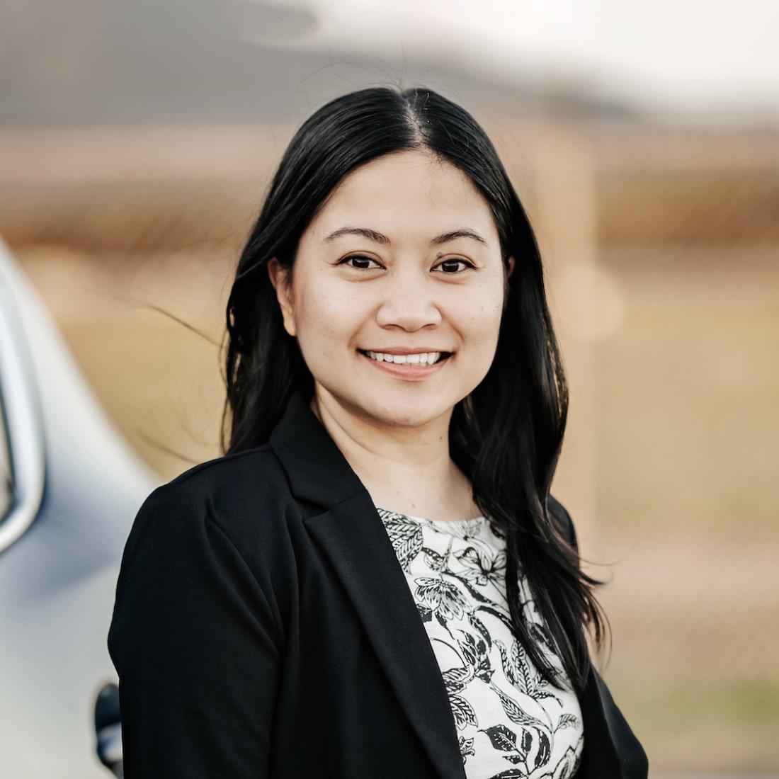 Trina Pinzon standinging and smiling Headshot