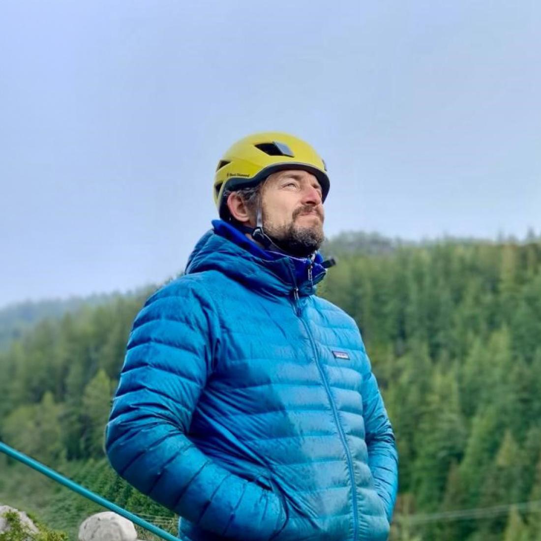 José Larochelle standing out side with trees and sky behind him