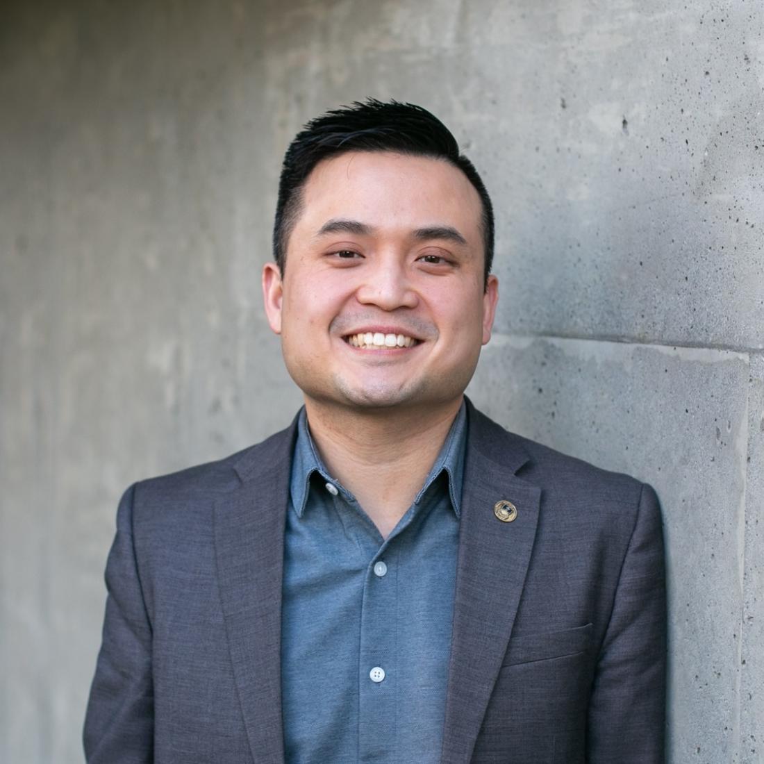 Clement Wee standing in front of grey wall