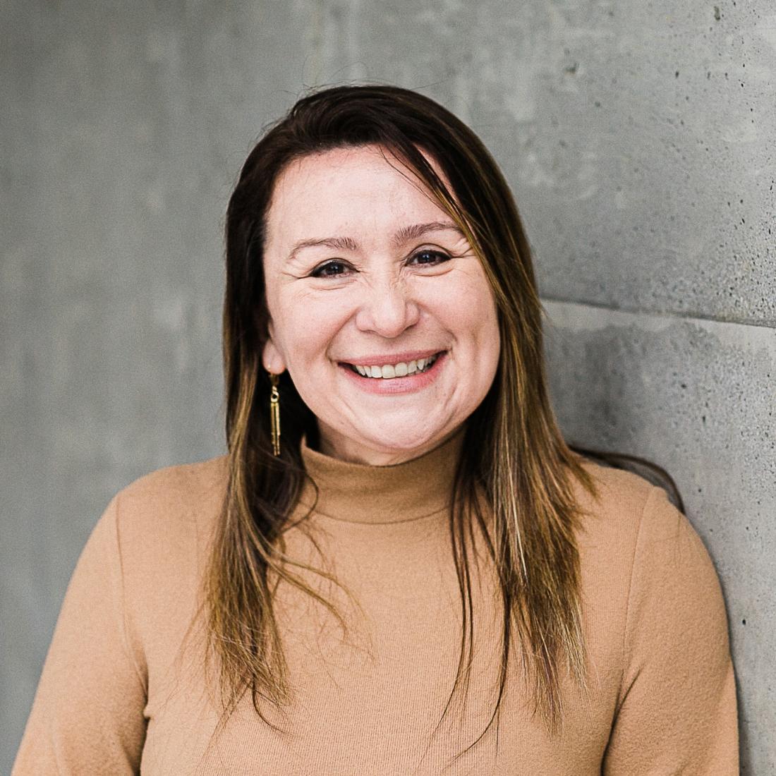 Ines Montoya standing in front of grey wall