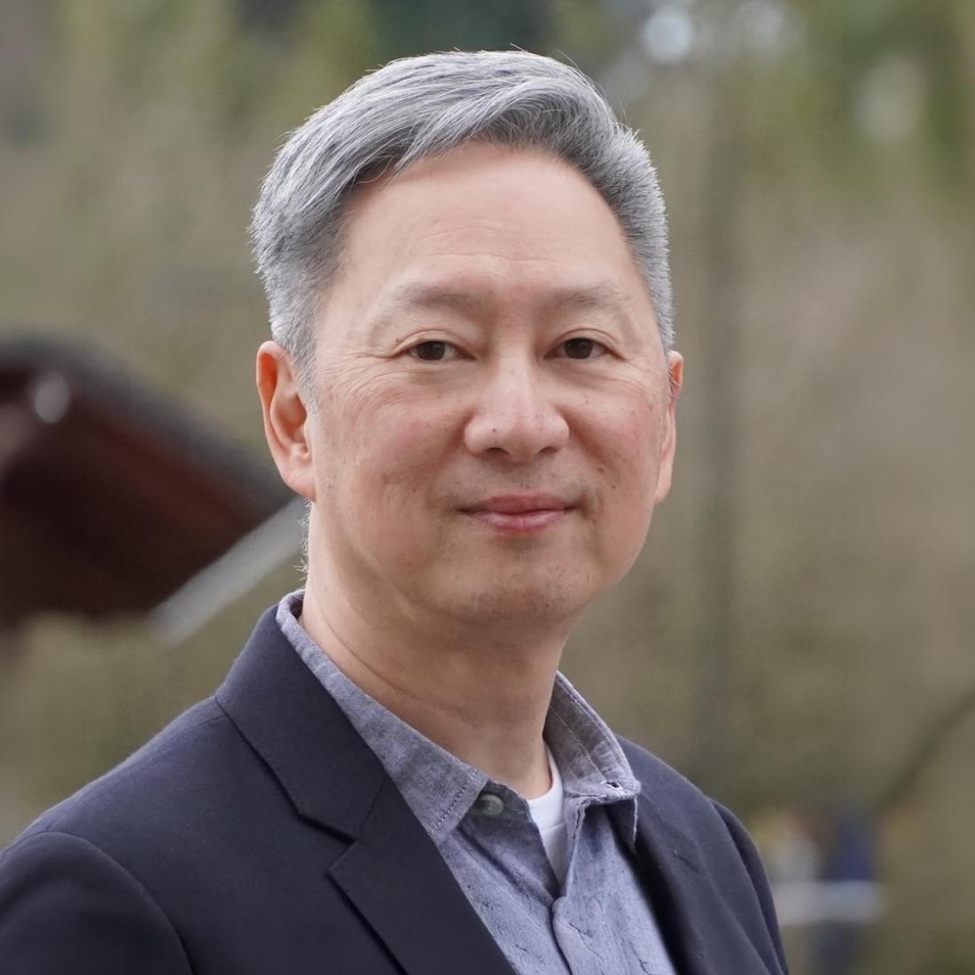 Kim Chen in a suit looking towards the camera