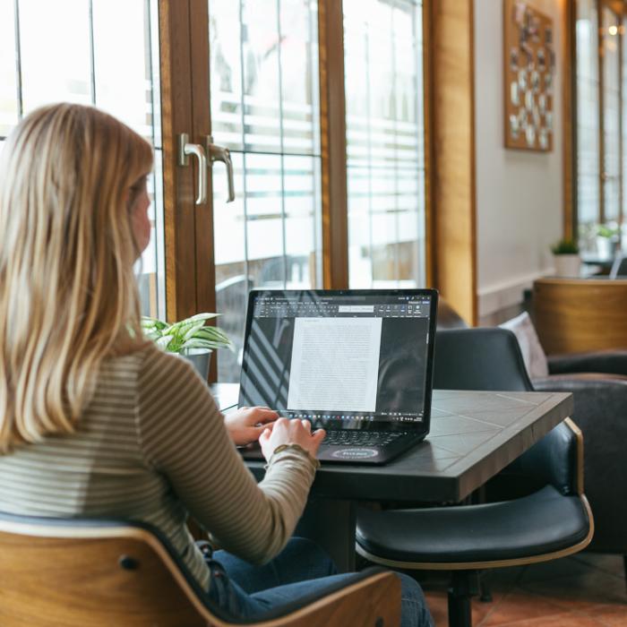 Female Student working on laptop in Trinity House