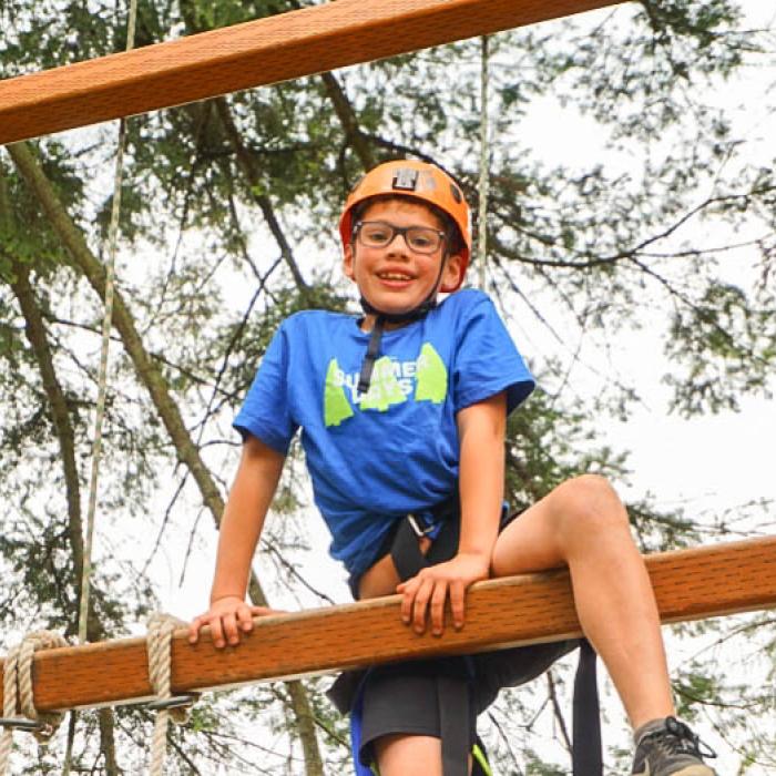 Young boy on the TWU Langley ropes course.