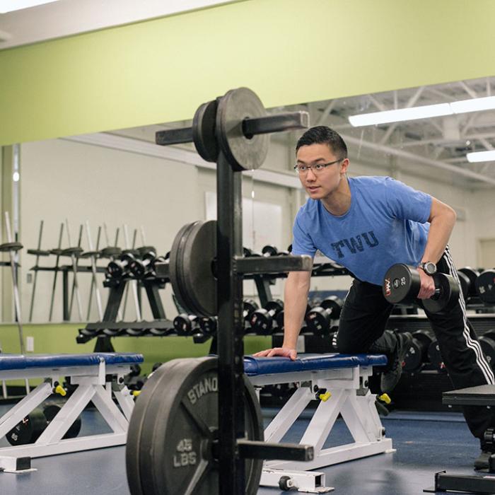 Student lifting dumbells