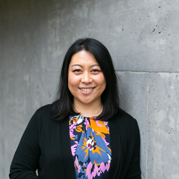 Chen Liu leaning on a wall