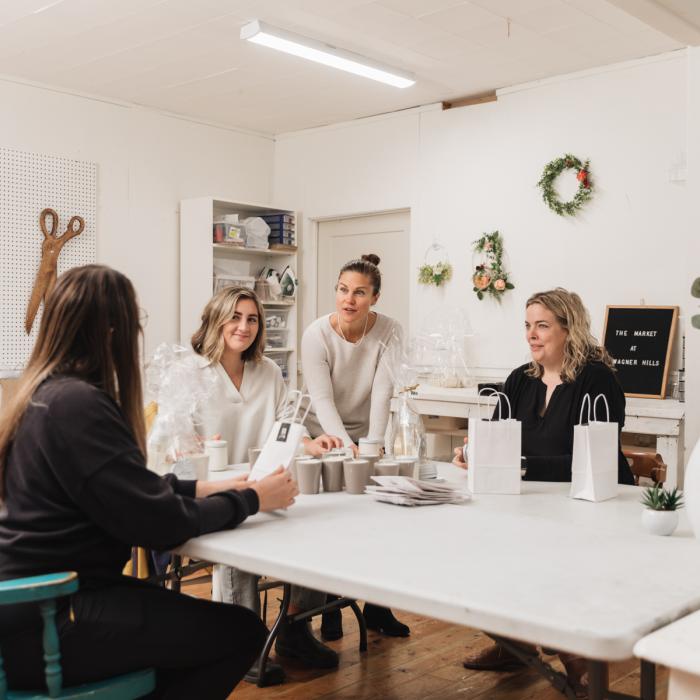 women sitting at table talking