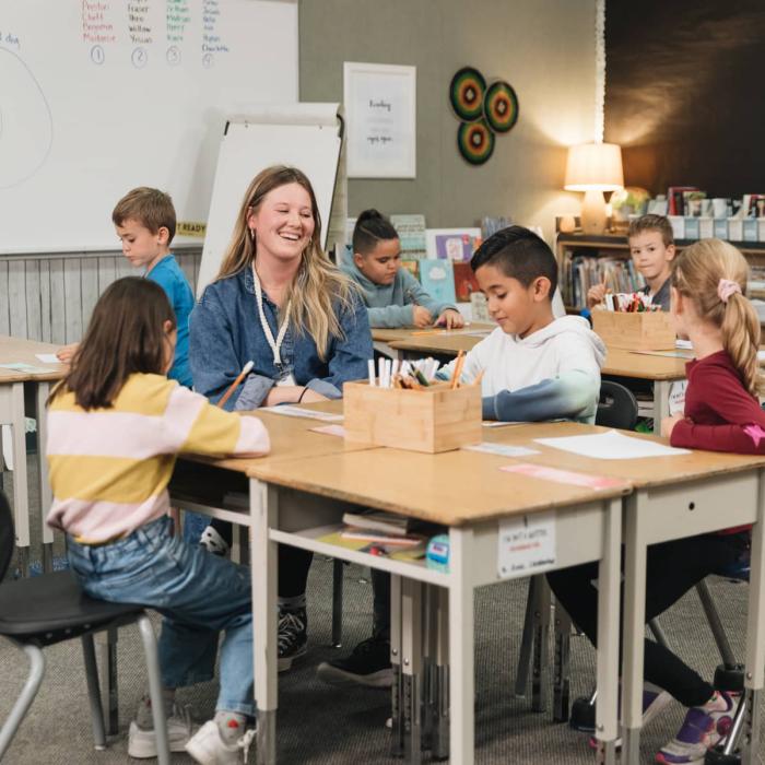 teacher working with students in classroom