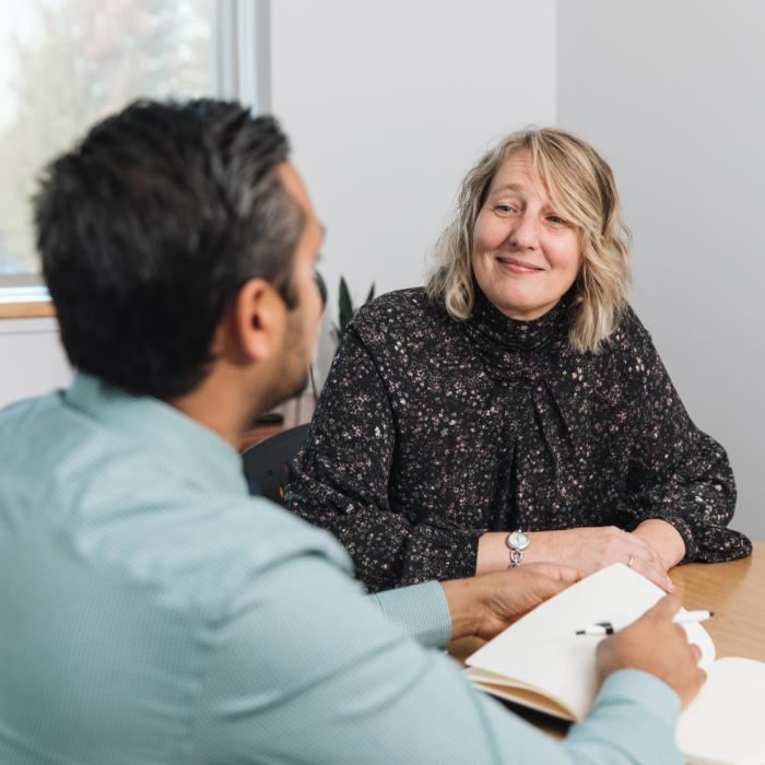 woman sitting at table talking to man