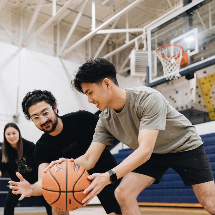 students playing basketball together