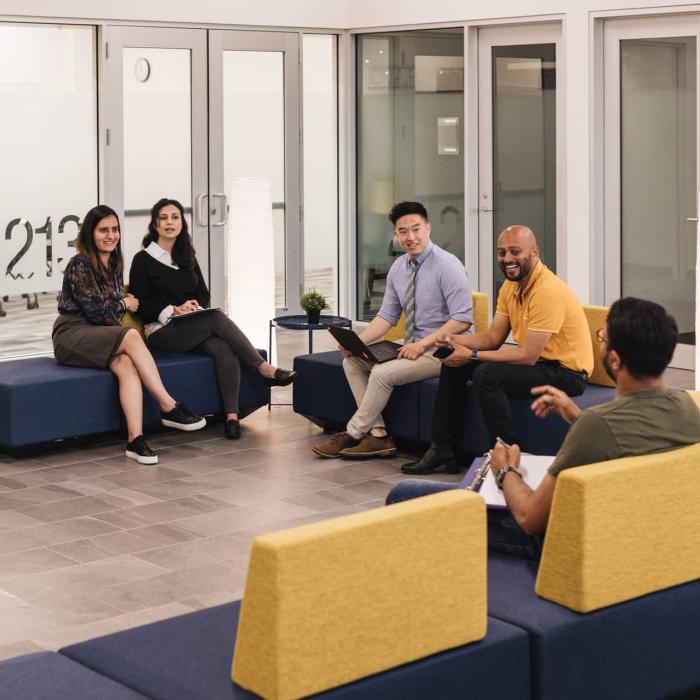 people sitting in a group talking and smiling