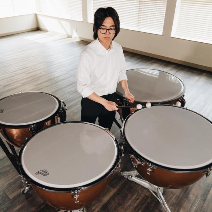 student playing drums