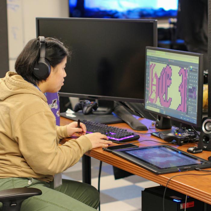 student working in computer lab to develop a game