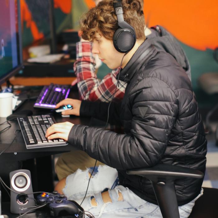 students wearing headphones and working on computers in lab