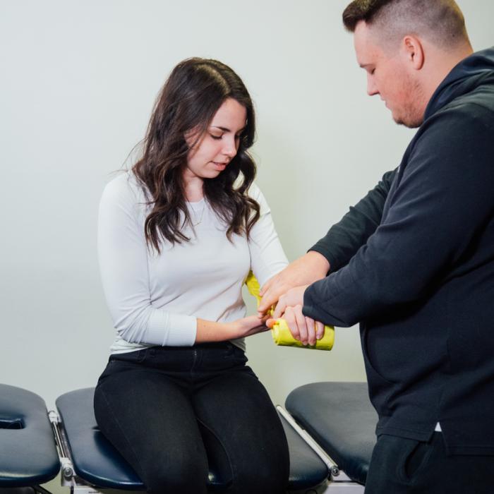 kinesiology student assisting another student