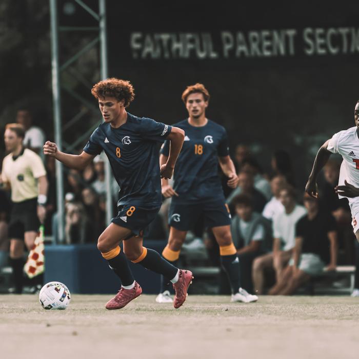 student athlete playing soccer on field