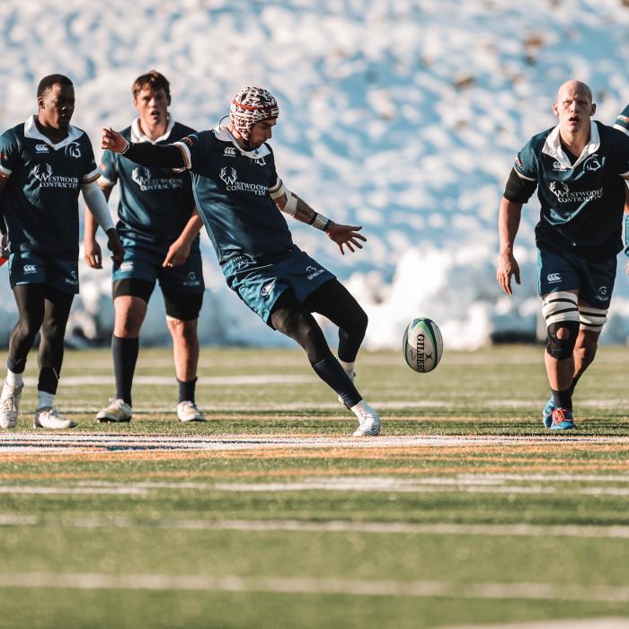 student athletes playing rugby on field