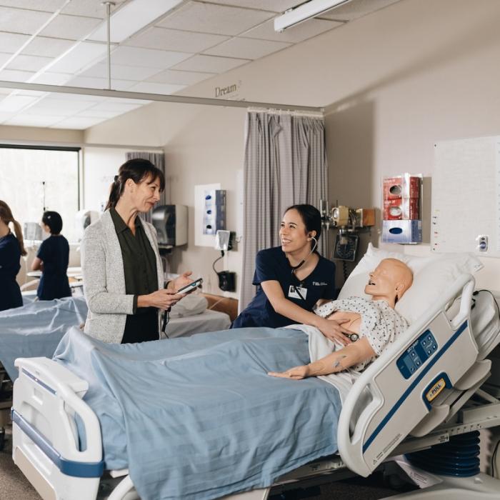 student and instructor working in nursing lab