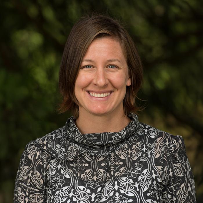 Laura Ginter headshot in front of green background